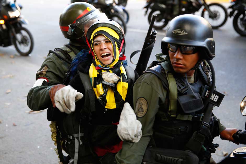 National guards transport an anti-government protester.jpg