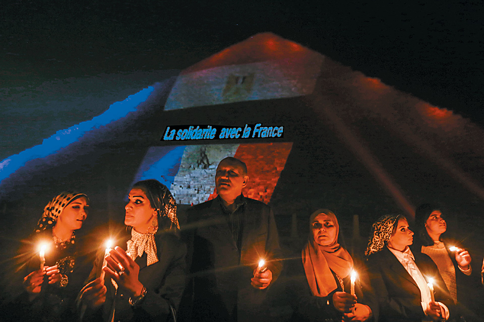 Egyptians attending a vigil at the Giza pyramids, near Cairo, for the victims of the recent attacks—claimed by ISIS—on Paris, Beirut, and the Russian passenger jet that exploded over the Sinai Peninsula, November 15, 2015
