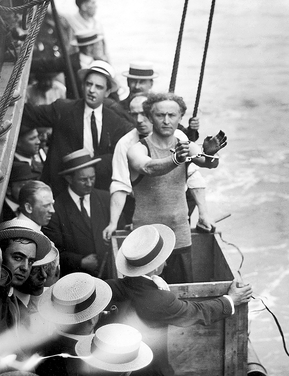 Harry Houdini, about to be padlocked into a packing case and lowered into New York Harbor, 1914