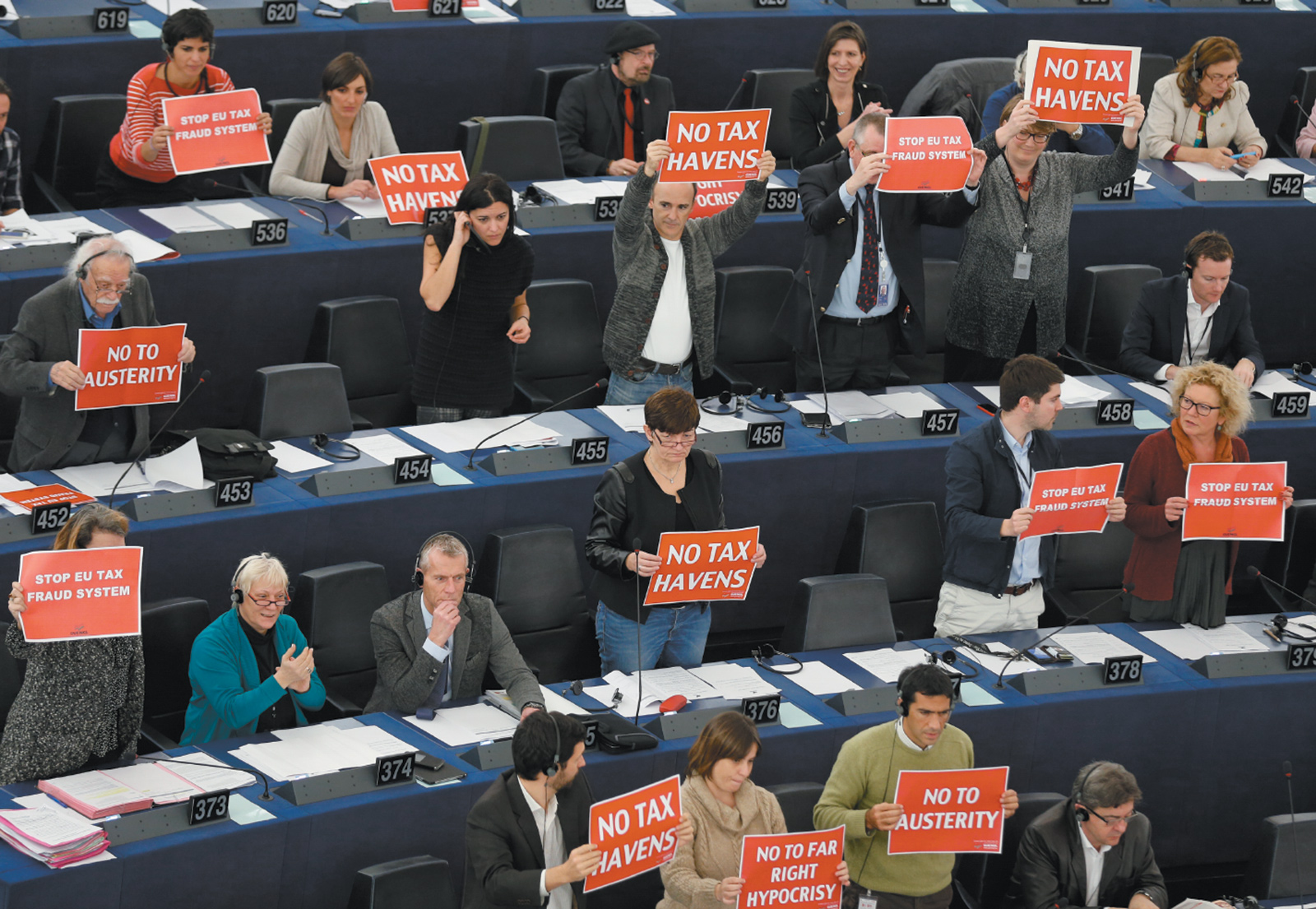 Members of the European Parliament in Strasbourg, France, holding signs in support of a motion to censure the European Commission under Jean-Claude Juncker because of the aggressive tax-avoidance policies pursued by Luxembourg while Juncker was prime minister, November 2014