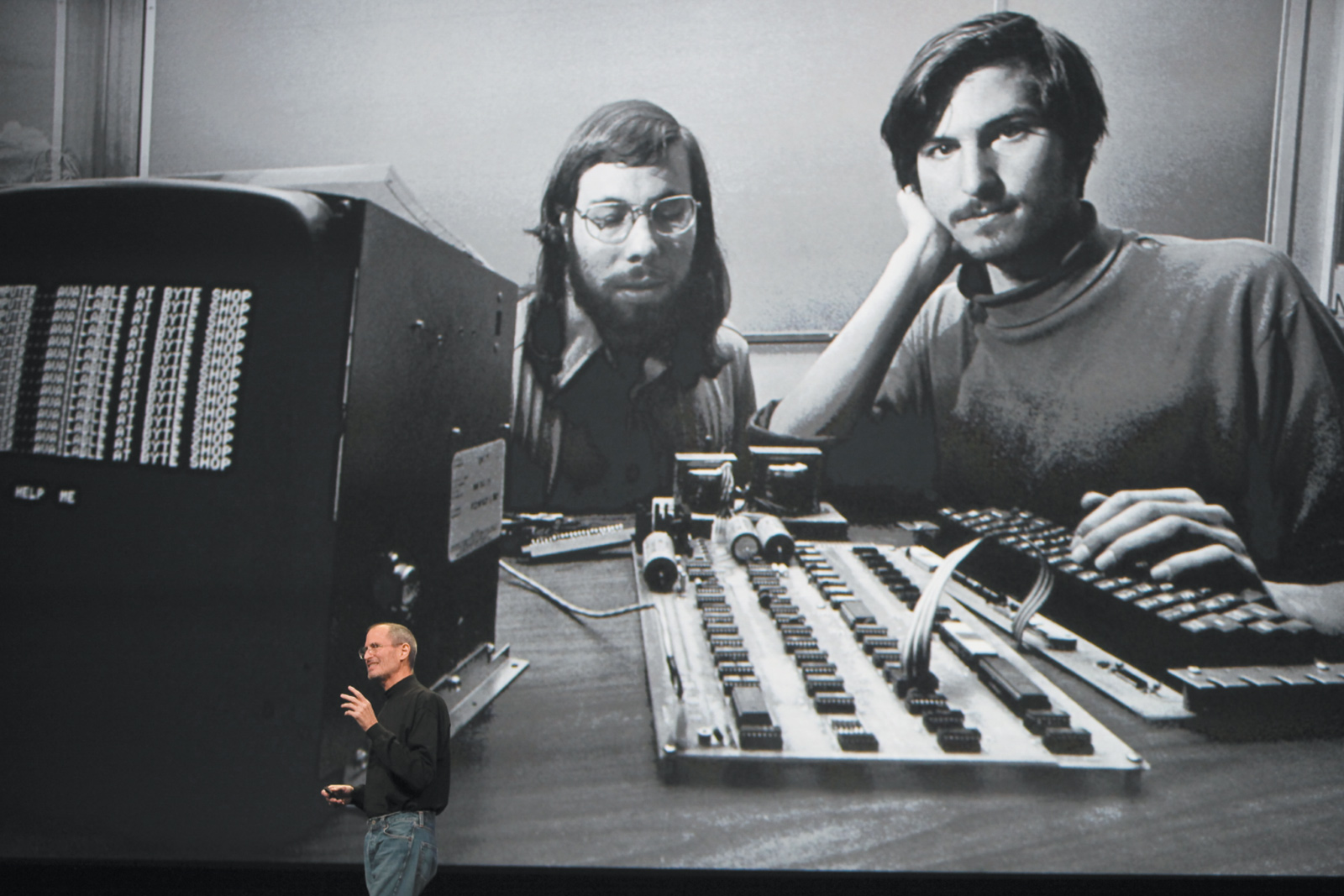 Steve Jobs speaking at a conference in San Francisco in front of a photograph of himself and Apple cofounder Steve Wozniak, 2010