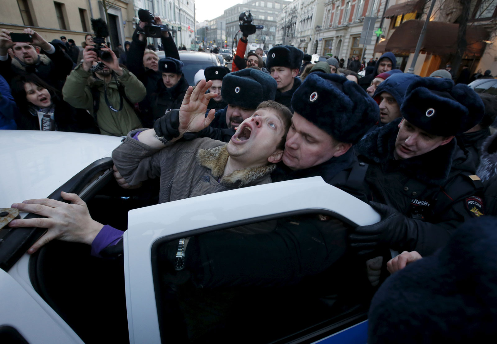 Police officers detain an activist who was taking part in a rally of foreign currency mortgage holders, near the Central Bank headquarters, Moscow, Russia, February 8, 2016 