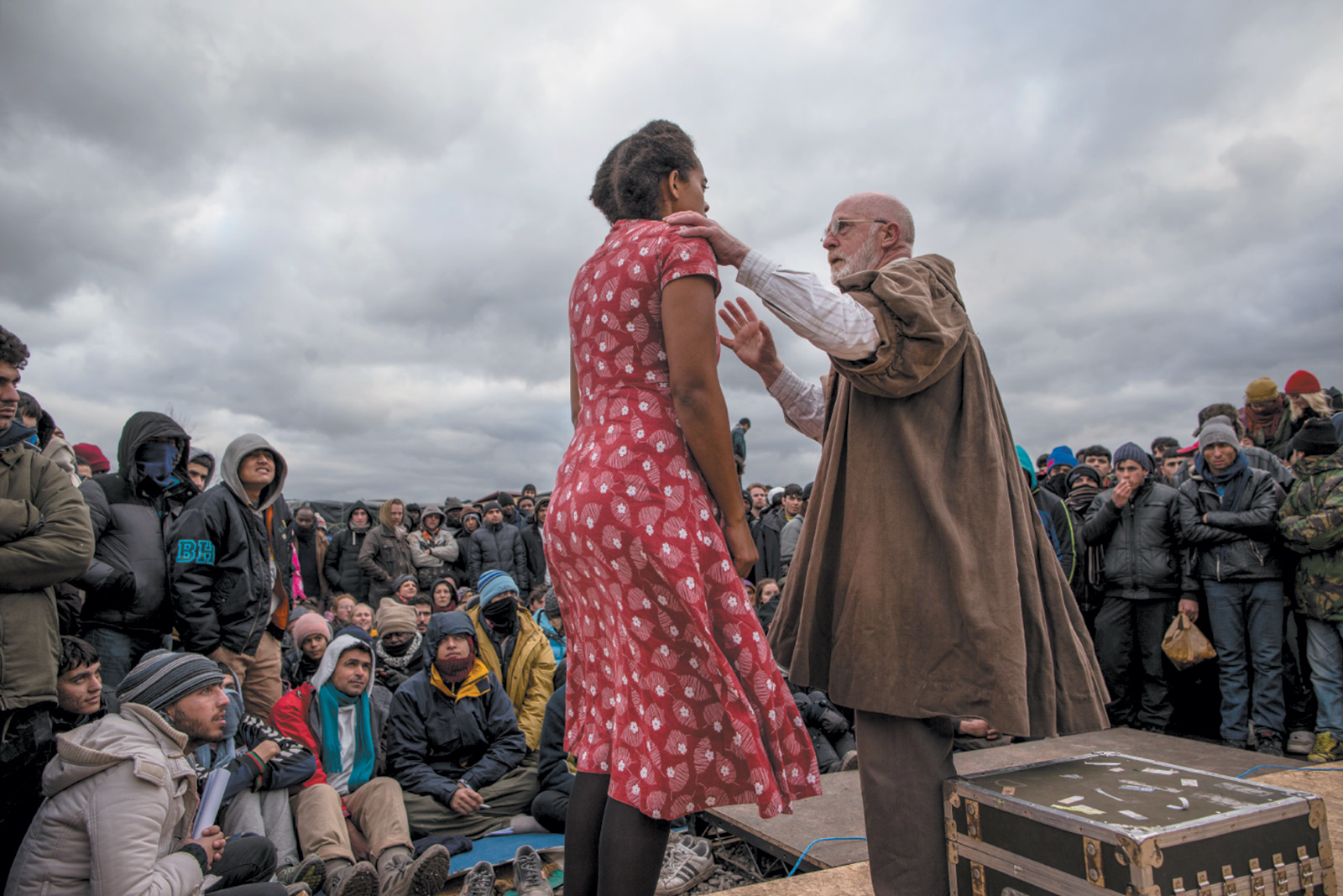 Actors from the Globe Theatre performing Hamlet for refugees and migrants in the Jungle refugee camp, Calais, France, February 2016