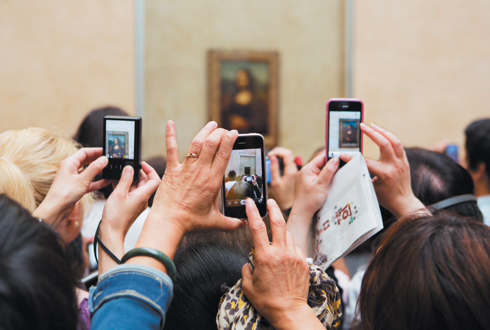 Museumgoers taking photographs of the Mona Lisa at the Louvre, Paris, 2012
