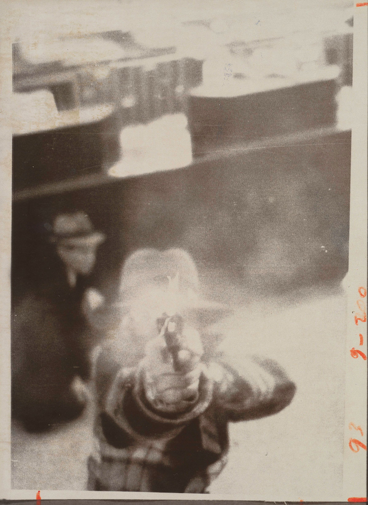A bank robber aiming at a security camera, Cleveland, March 8, 1975