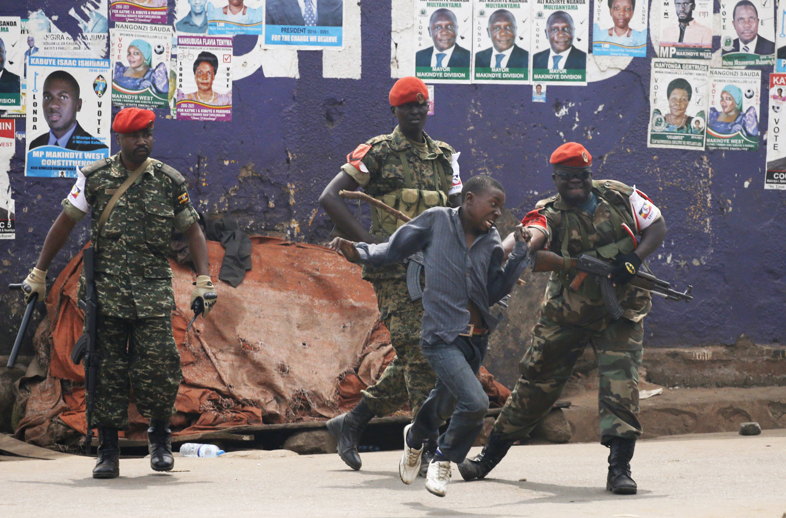 Policemen and a supporter of opposition leader Kizza Besigye, Kampala, Uganda February 19, 2016