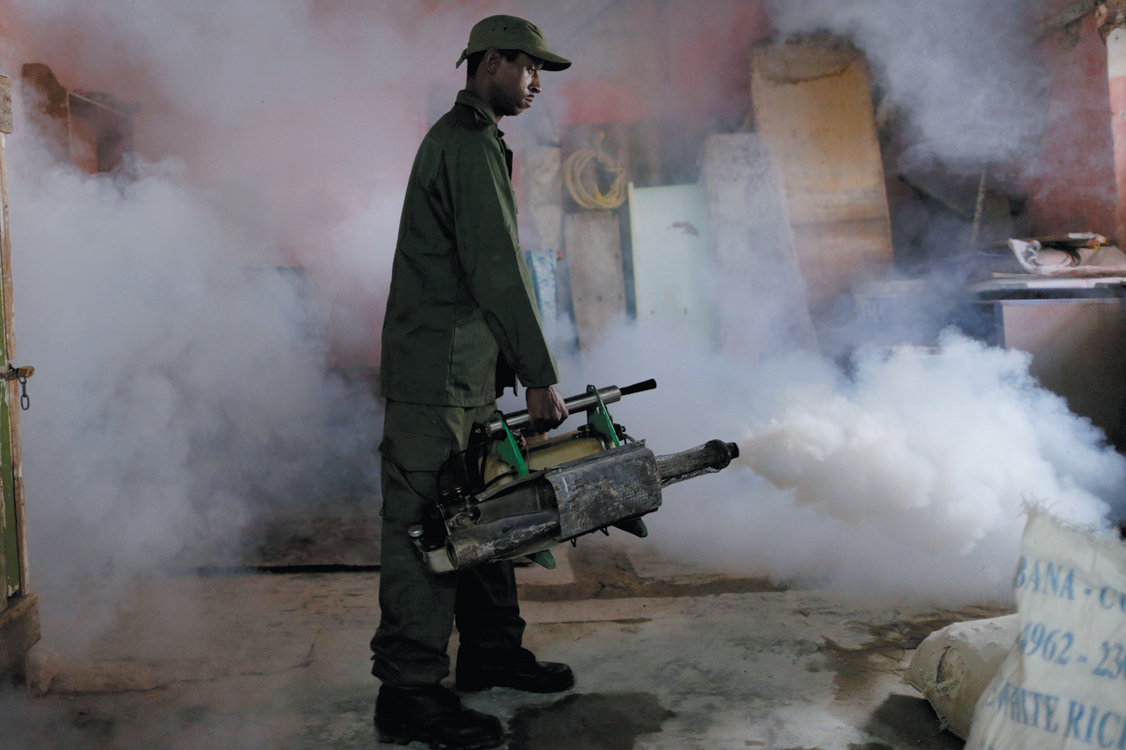 A military reservist fumigating a house as a preventive measure against the Zika virus and other mosquito-borne diseases, Havana, Cuba, March 2016