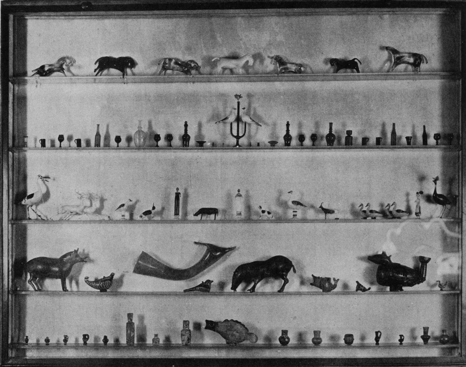Glass shelves displaying glass objects, in the dining room of the Nadelmans' New York townhouse, 1925