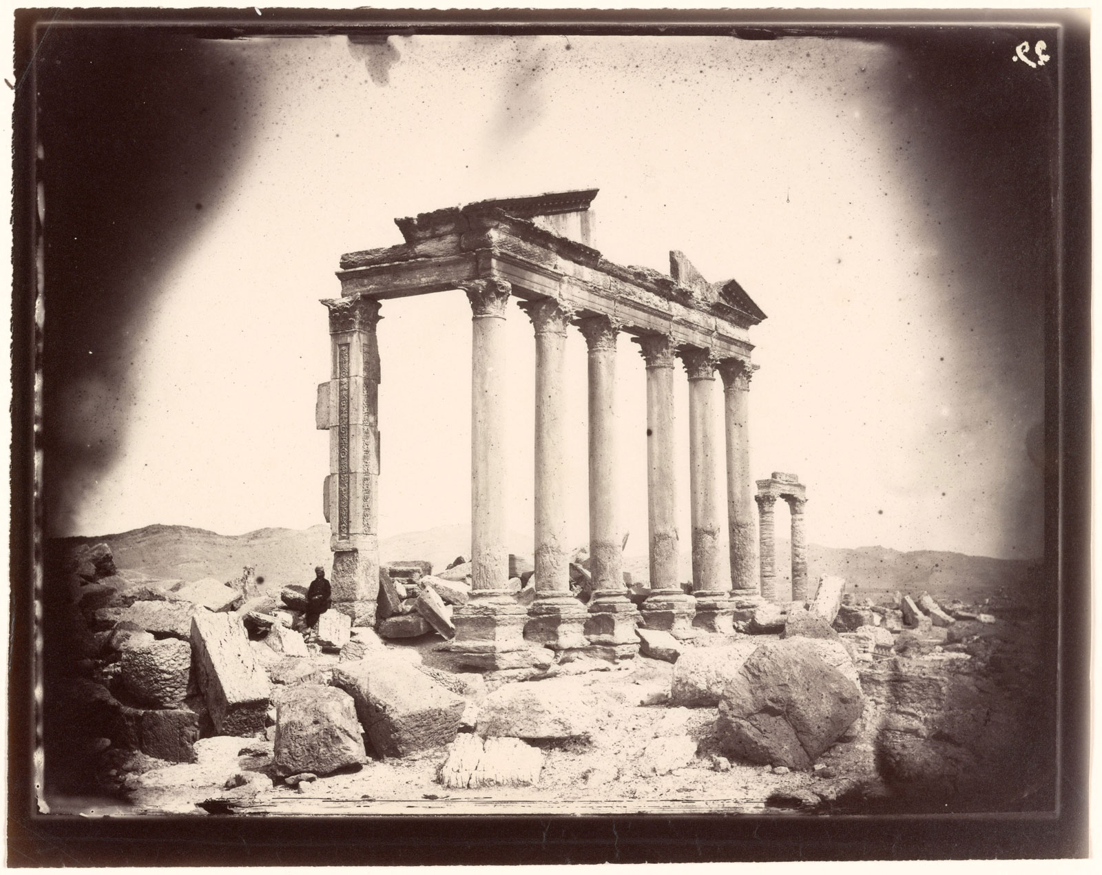 Man leaning against a Column of Funerary Temple no. 86 