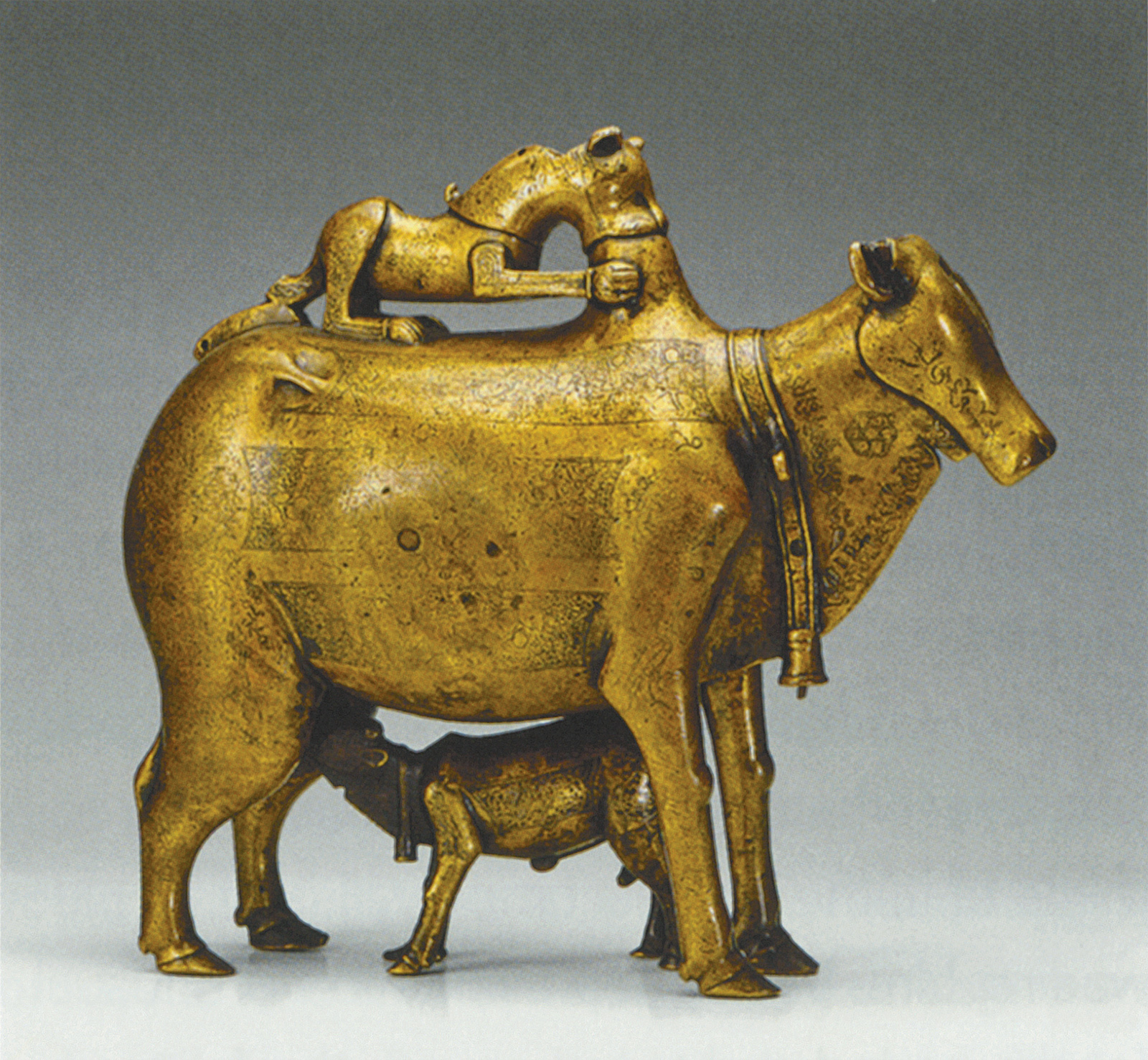A bronze aquamanile of a cow suckling her calf and being attacked by a lion, Khurasan, 1206 CE