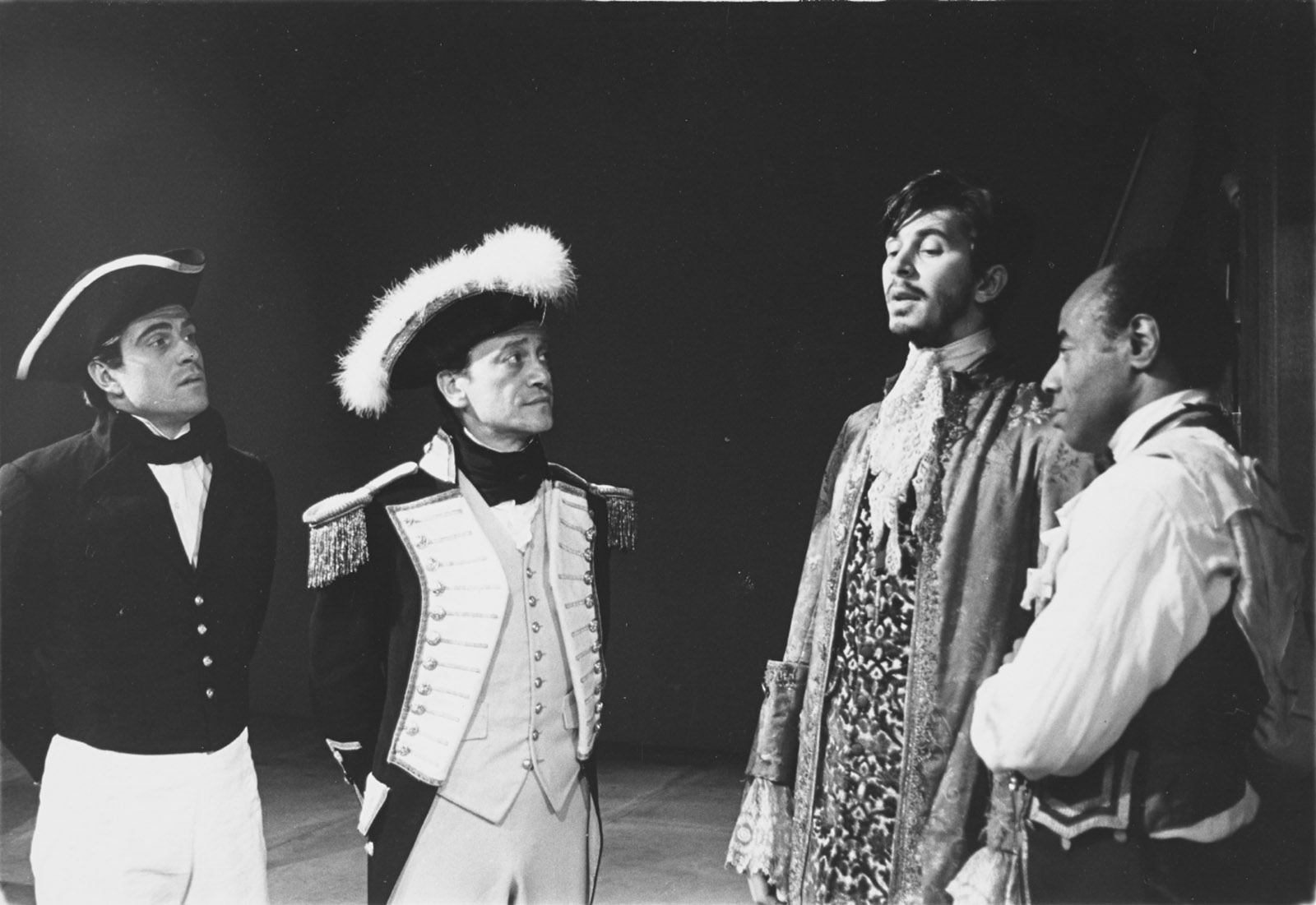 A scene from the first production of Robert Lowell’s Benito Cereno, part of his trilogy, The Old Glory, directed by Jonathan Miller at the American Place Theater in 1964 and based on Herman Melville’s novella. Captain Amasa Delano (Lester Rawlins, second from left), who has boarded the slave ship San Dominick off the coast of Trinidad, is listening to its captain, Don Benito Cereno (Frank Langella), and is still unaware that the slaves, under the command of Cereno’s servant, Babu (Roscoe Lee Browne, right), have taken over the ship.