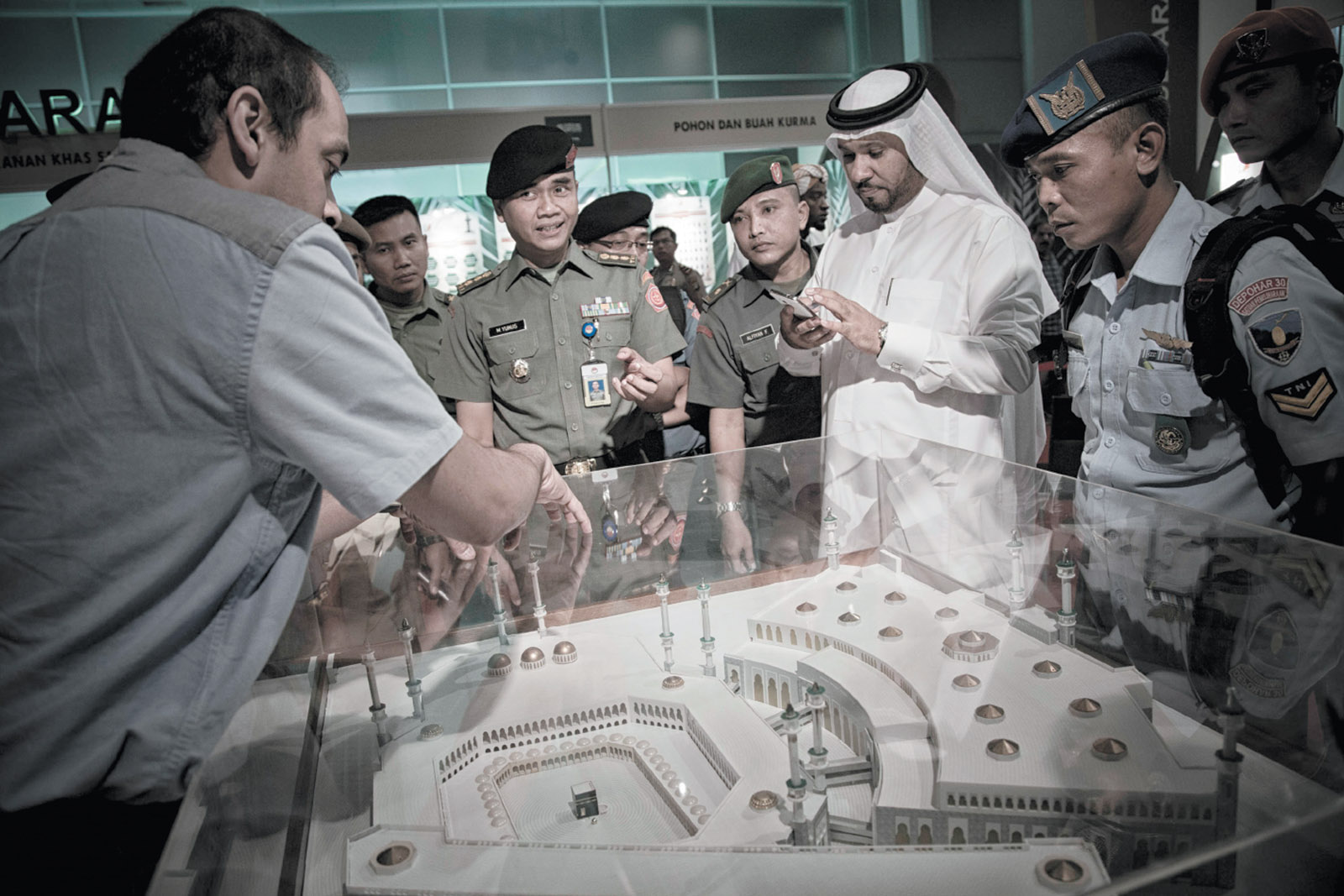 A Saudi official explaining a maquette of the mosque at Mecca to members of the Indonesian military at  a Saudi-sponsored festival in Jakarta, March 2016