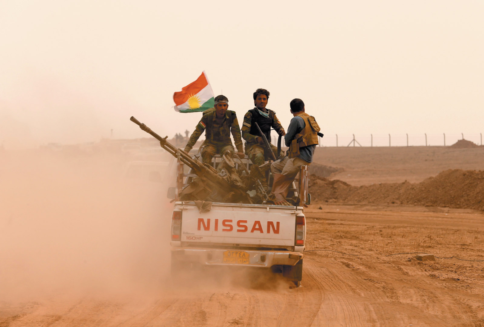 Kurdish peshmerga fighters at the front line during a battle with Islamic State militants near Mosul, Iraq, October 2016