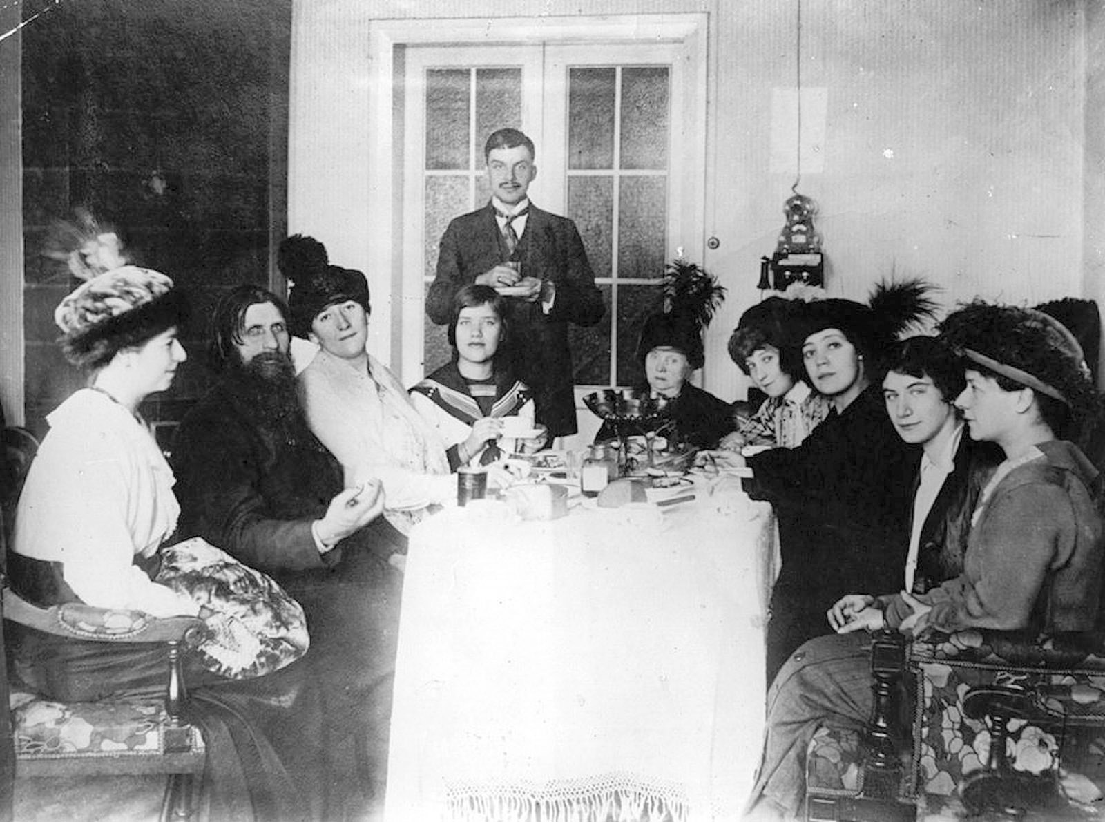 Rasputin with some of his admirers, St. Petersburg, circa March 1914. Among them xare Tsarina Alexandra’s close friend Lily Dehn (third from left), Rasputin’s daughter Maria (fourth from left), and Munya Golovina (far right), a devoted disciple who introduced Rasputin to Felix Yusupov, one of his killers.