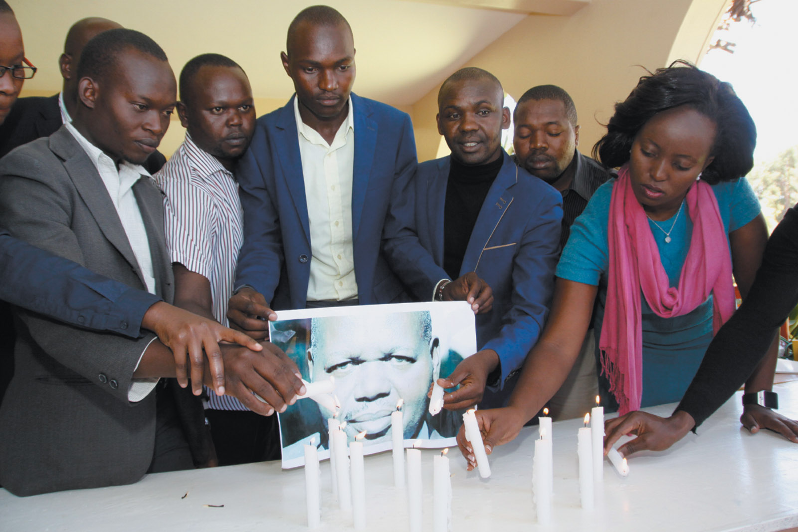 Journalists lighting candles in memory of newspaper editor John Kituyi on World Press Freedom Day, Eldoret, Kenya, May 2016. Kituyi was killed the year before while preparing to publish the results of an investigation that, according to Alan Rusbridger, ‘could have embarrassed leading figures in Kenya’s national government.’