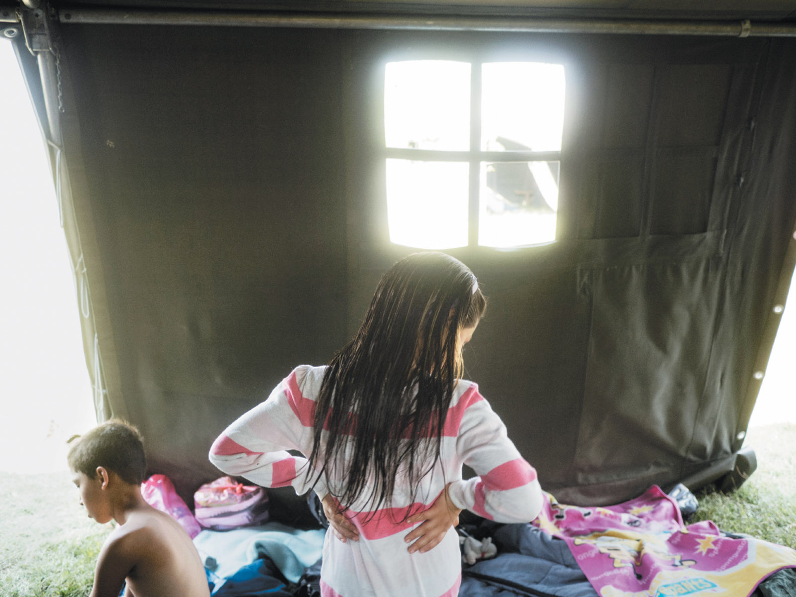Syrian refugees resting at an aid center on the Serbian side of the border before attempting to cross into Hungary, August 2015