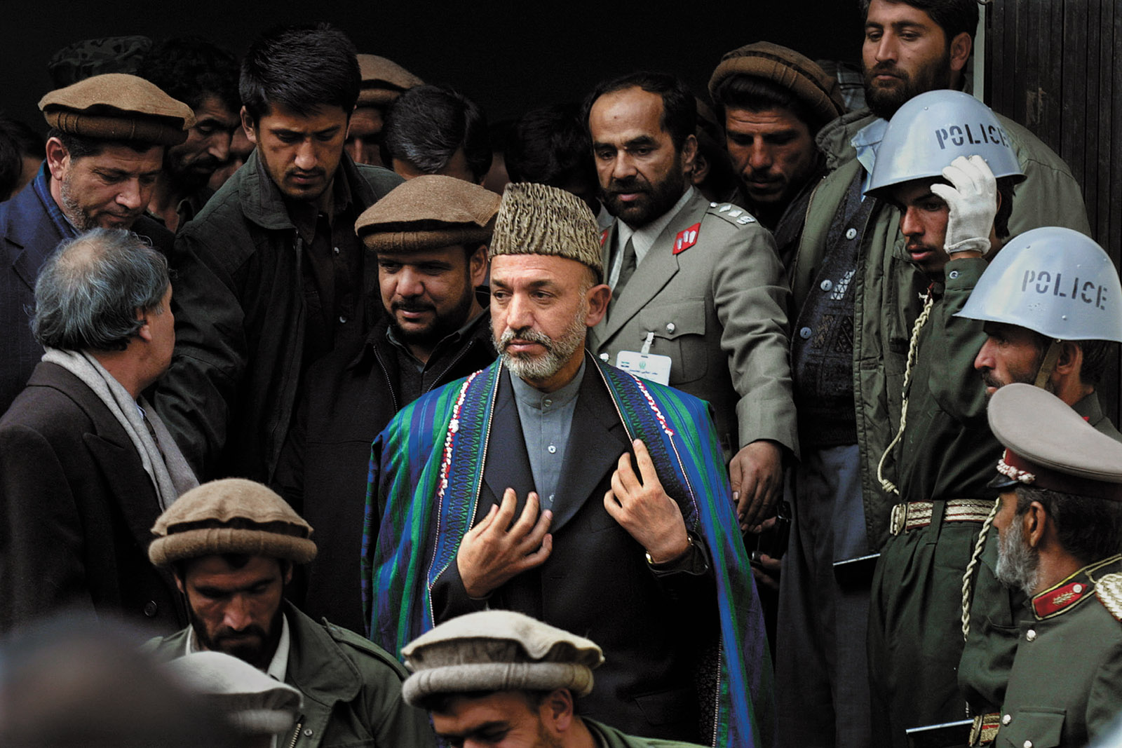 Hamid Karzai leaving the Interior Ministry after being sworn in as prime minister of Afghanistan’s interim government, Kabul, December 2001; photograph by Paula Bronstein from her book Afghanistan: Between Hope and Fear, just published by University of Texas Press