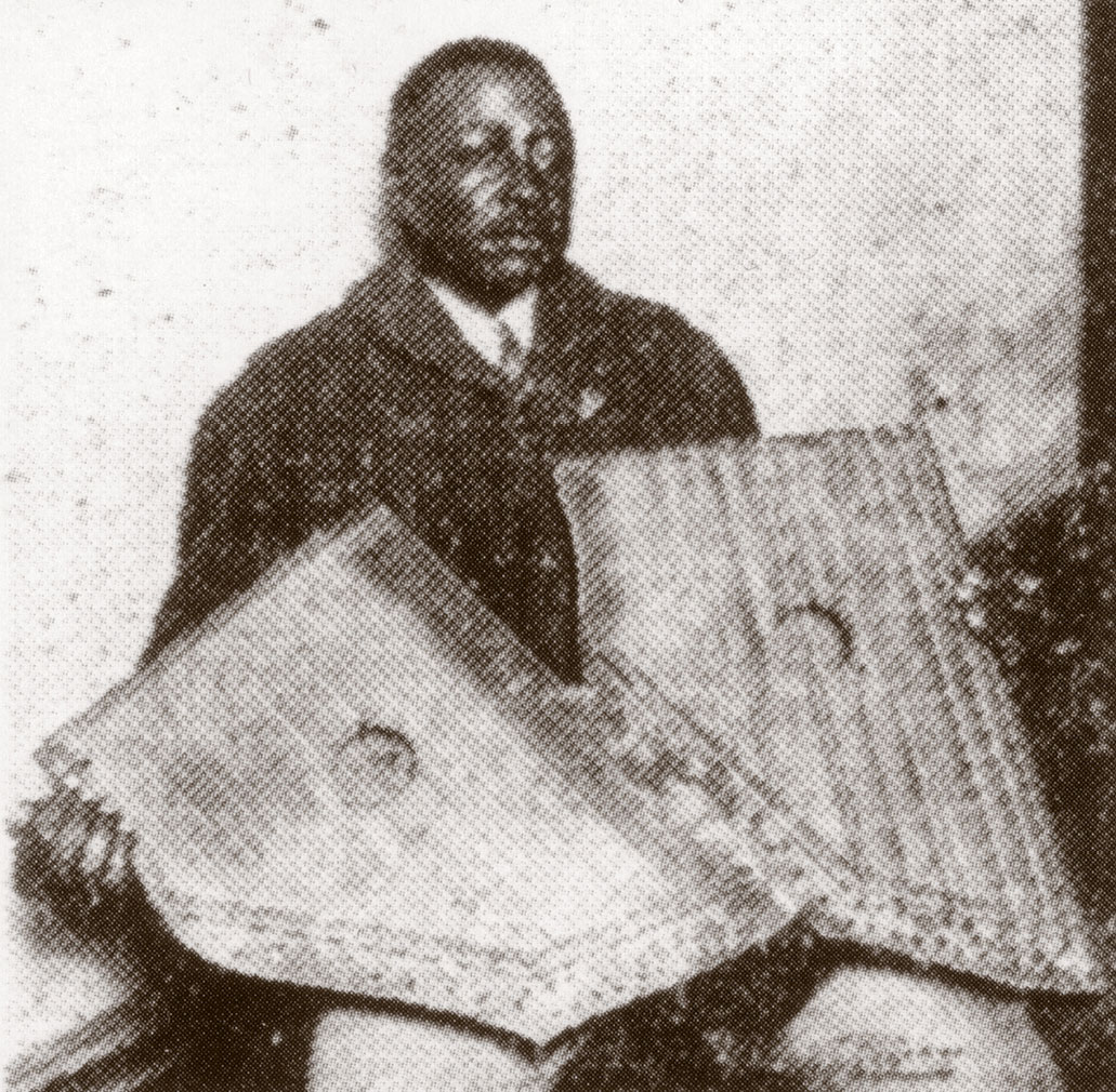 Phillips during a recording session, holding two zithers that seem to be attached, December 1927 