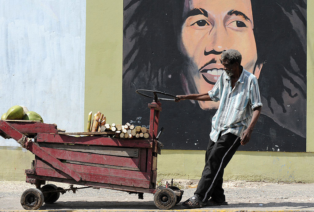 A vendor pulling his cart in front of a mural of Bob Marley, Kingston, Jamaica, February 8, 2009