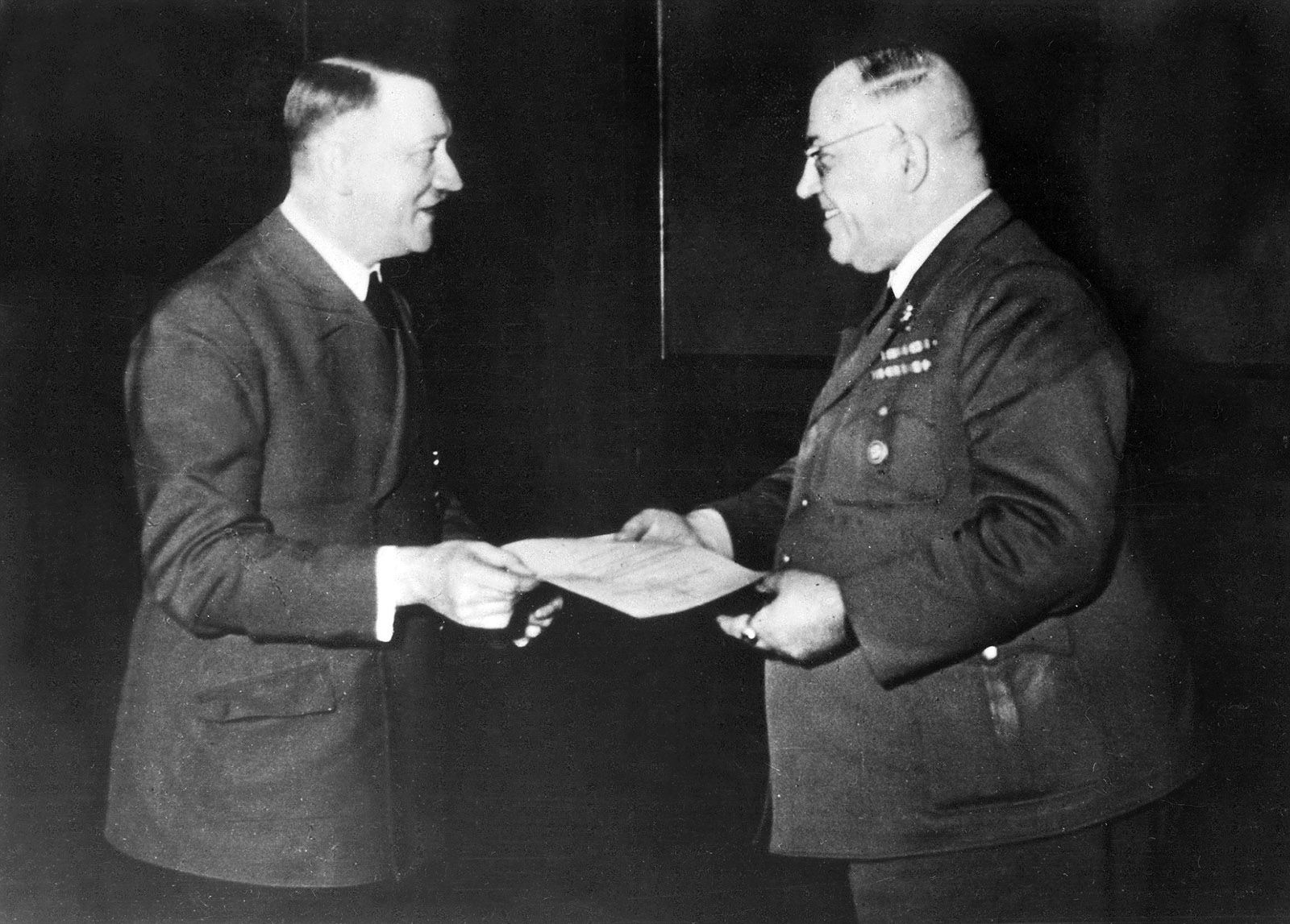 Adolf Hitler presenting Theodor Morell, his personal physician, with the Knight’s Cross of the War Merit Cross at his headquarters, 1944