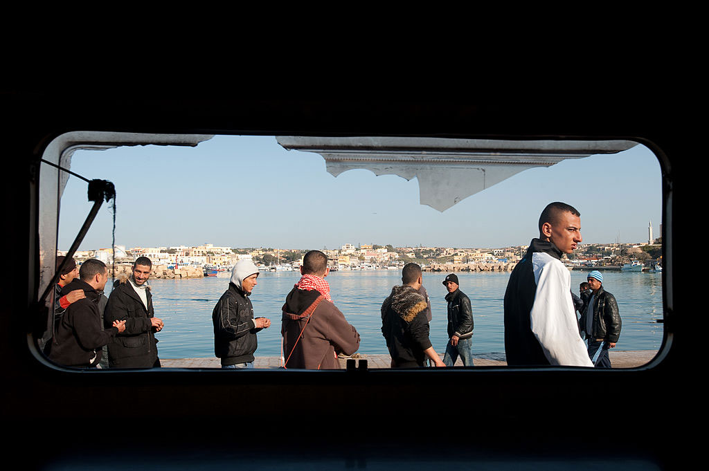 Migrants who have arrived by boat from North Africa at the port in Lampedusa, March, 2011