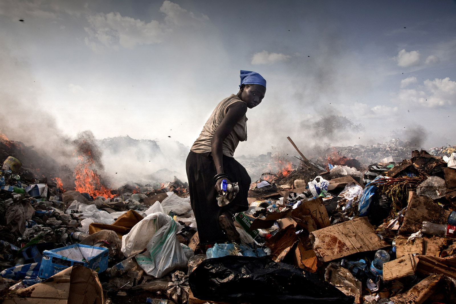 A woman walking through the landfill where she lives, Juba, South Sudan, 2010