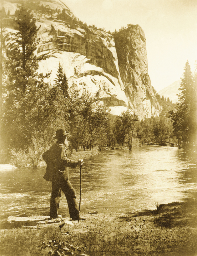 John Muir at the Merced River, with the Royal Arches and the Washington Column in the background, Yosemite National Park, California, circa 1909
