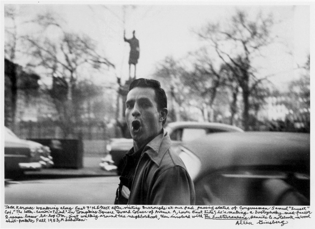 Jack Kerouac; photograph by Allen Ginsberg, 1953. Ginsberg’s caption reads: ‘Jack Kerouac wandering along East 7th Street after visiting Burroughs at our pad, passing statue of Congressman Samuel “Sunset” Cox, “The Letter-Carrier’s Friend” in Tompkins Square toward corner of Avenue A, Lower East Side; he’s making a Dostoyevsky mad-face or Russian basso be-bop Om, first walking around the neighborhood, then involved with The Subterraneans, pencils & notebook in wool shirt-pockets, Fall 1953, Manhattan.”
