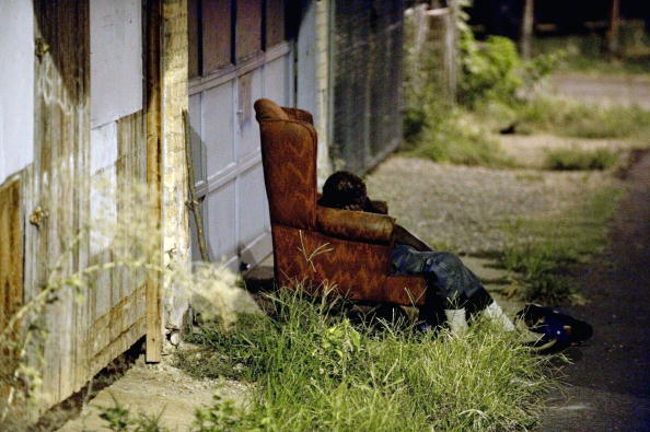A homeless person sleeping in an armchair in an alleyway, Washington D.C., September 1, 2010