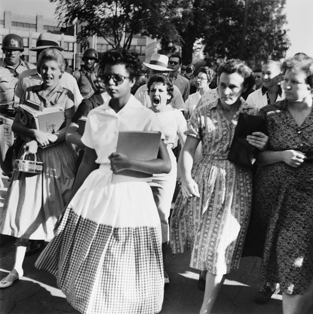 Elizabeth Eckford, one of the Little Rock Nine—a group of African-American students enrolled in the segregated Little Rock Central High School following the Brown decision—pursued by a mob on the first day of the school year, September 4, 1957. Arkansas National Guardsmen sent by Governor Orville Faubus blocked the nine from entering the school; three weeks later President Eisenhower sent federal troops to protect them and enforce desegregation.