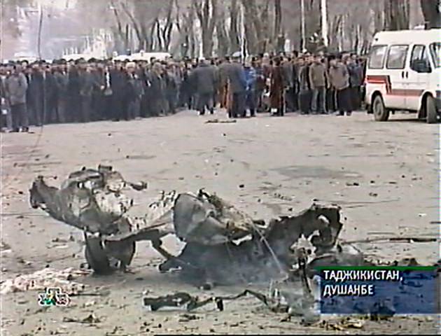 An image taken from Russian Independent Television showing Tajiks looking on after a car loaded with explosives blew up in the Tajik capital Dushanbe, January 31, 2005