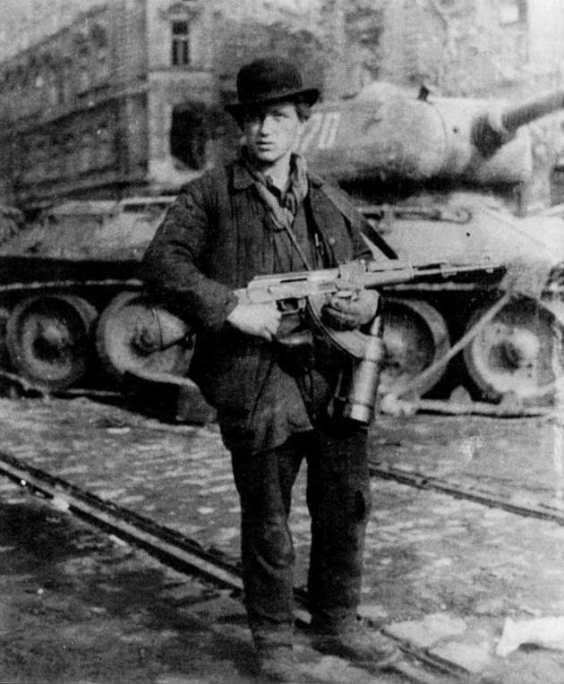 József Tibor Fejes, a young Hungarian identified by C. J. Chivers in The Gun as ‘the first known insurgent to carry an AK-47.’ According to Chivers, ‘Fejes obtained his prize after Soviet soldiers dropped their rifles during their attack on revolutionaries in Budapest in 1956.... The Hungarian Revolution marked the AK-47’s true battlefield debut.’