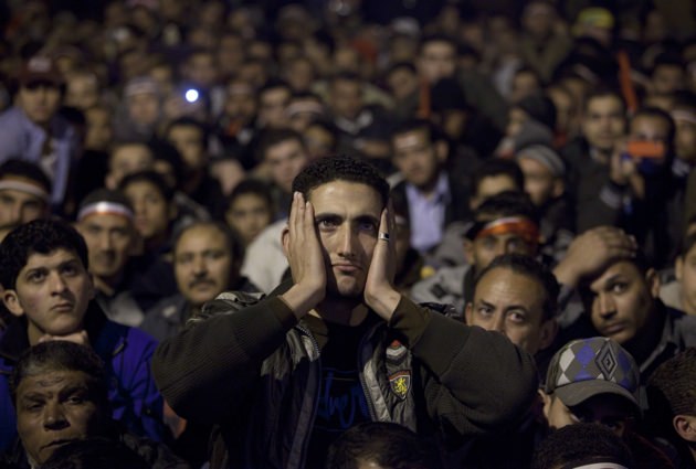 Anti-government protesters watching Egyptian President Hosni Mubarak making a televised statement, Tahrir Square, February 10, 2011
