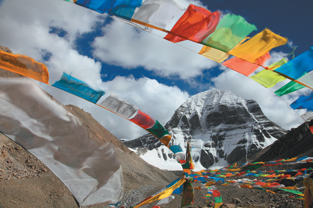 Buddhist prayer flags at the base of Mount Kailas in Tibet, where pilgrims come to walk the perimeter of the mountain, and where some monks and nomads follow the practice of sky burial. ‘Especially in this propitious month of Saga Dawa,’ Colin Thubron writes, ‘people may repair to lie down and enact their own passing.’