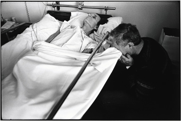 Joe is stricken with grief when visiting Bill. He cries into the bed sheet to keep Bill from seeing him. Hospice of Marin County, 1982