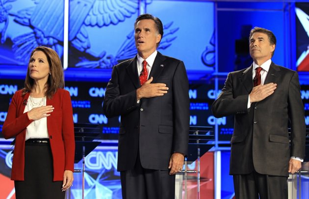 Michele Bachmann, Mitt Romney and Rick Perry during the playing of the National Anthem before a Republican presidential debate,Tampa, Florida, September 12, 2011 