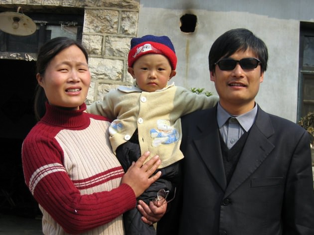 Chen Guangcheng with his wife and child outside their home in Dondshigu village, Shandong province, northeast China, March 28, 2005
