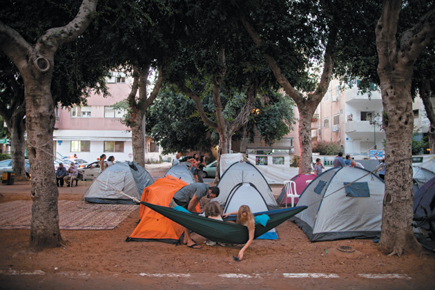 An Israeli family in a camp set up as part of a protest against the high cost of housing, Tel Aviv, Israel, July 23, 2011
