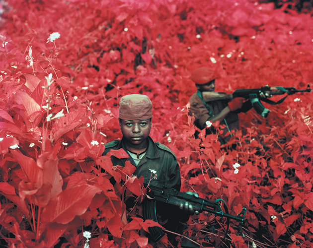Young rebels from the Alliance of Patriots for a Free and Sovereign Congo—whose fighters, according to UNHCR, are told to spray themselves with ‘magic water to protect themselves from bullets’—Lukweti, Masisi Territory, North Kivu, 2011. The photograph is titled Vintage Violence and appears in Infra, Richard Mosse’s book of infrared images of eastern Congo. The book includes an essay by Adam Hochschild and has just been published by Aperture and the Pulitzer Center on Crisis Reporting.
