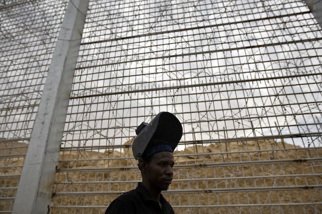 Sudanese immigrant Mohammed Yussef works at the construction site of a border fence along Israel's border with Egypt near the Red Sea resort town of Eilat, February 15, 2012