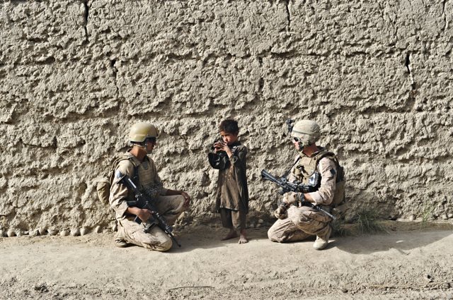 US marines talking to a Pashtun child whose father is a Taliban suspect, Afghanistan, August 17, 2009