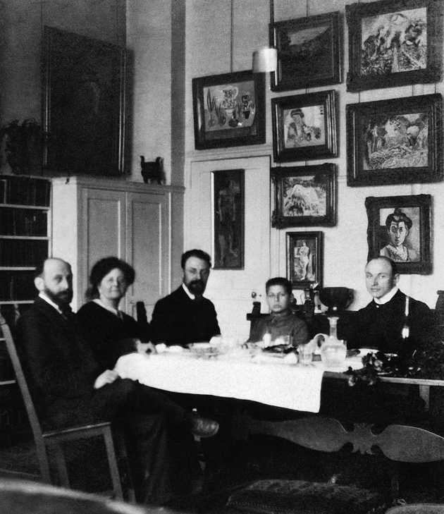 Henri Matisse (center) and Hans Purrmann (right) dining with Michael, Sarah, and Allan Stein at their apartment at 58 rue Madame, Paris, circa 1908. The paintings in the background, all by Matisse, are The Young Sailor I (far left); Pink Onions and Male Nude (left column); Fruit Trees in Blossom, Woman in a Kimono, Nude Reclining Woman, and Nude before a Screen (center column); Madame Matisse in the Olive Grove, a sketch for Le Bonheur de Vivre, and Madame Matisse (The Green Line) (right column).