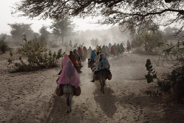 Women in Darfur returning from Kutum market to the Fata Borno camp for internally displaced persons under the protection of African Union soldiers, January 2007; photograph by Gary Knight from Questions Without Answers: The World in Pictures by the Photographers of VII. The book has just been published by Phaidon.
