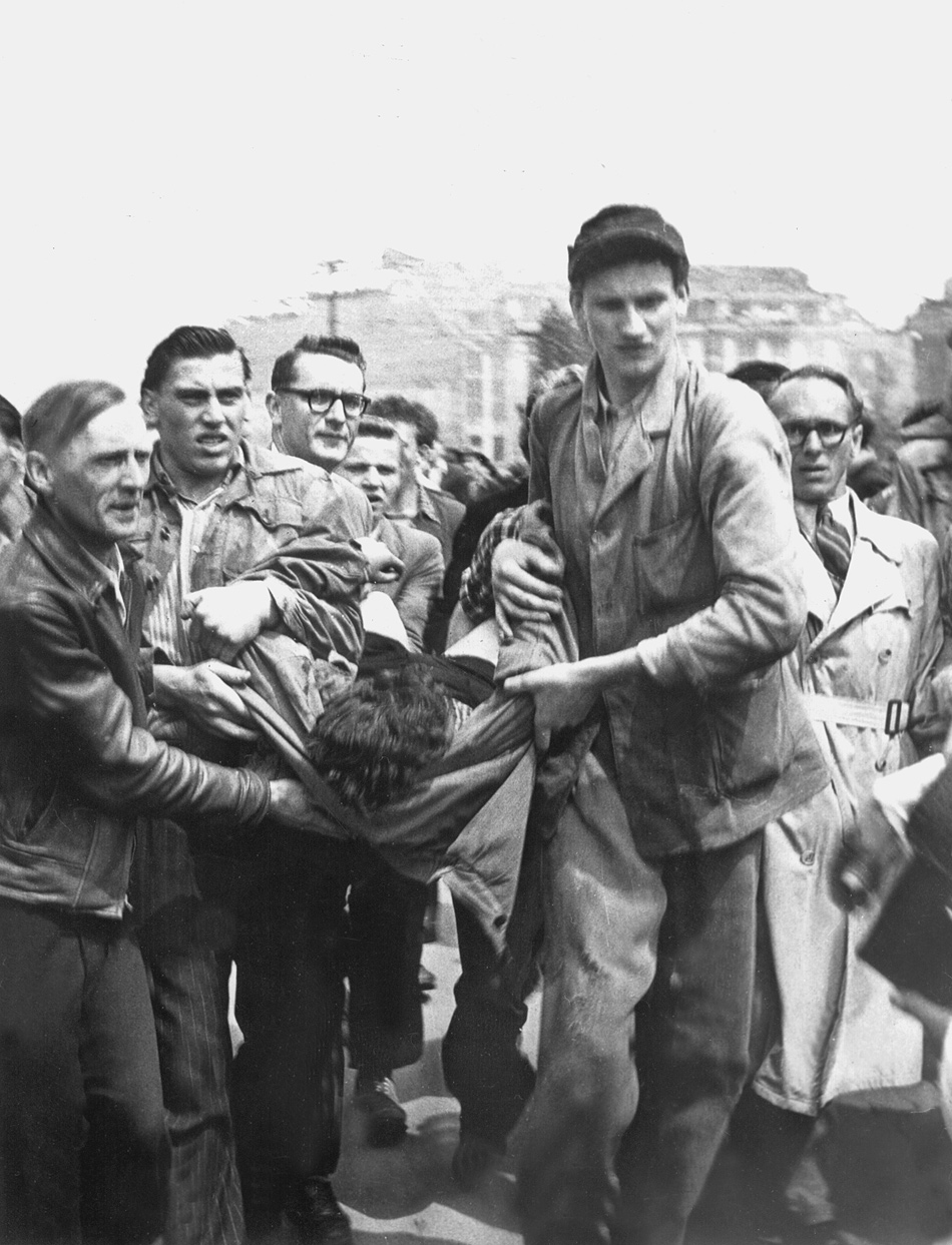 A wounded protester being carried away after an anti-Soviet demonstration, Berlin, June 17, 1953; the photographs on this page and page 48 are from Anne Applebaum’s Iron Curtain: The Crushing of Eastern Europe, 1944–1956
