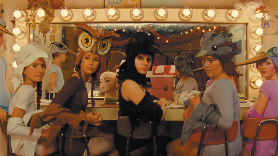 Kara Hayward (center) in Wes Anderson’s Moonrise Kingdom, in a scene showing preparations for a production of Benjamin Britten’s opera Noye’s Fludde