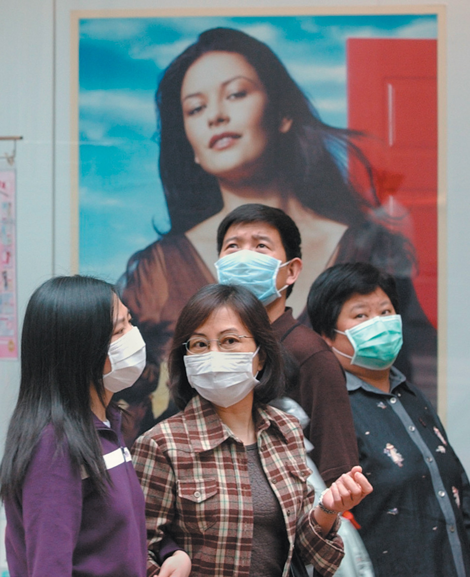 People wearing surgical masks to protect themselves from the SARS virus, Hong Kong, April 2003