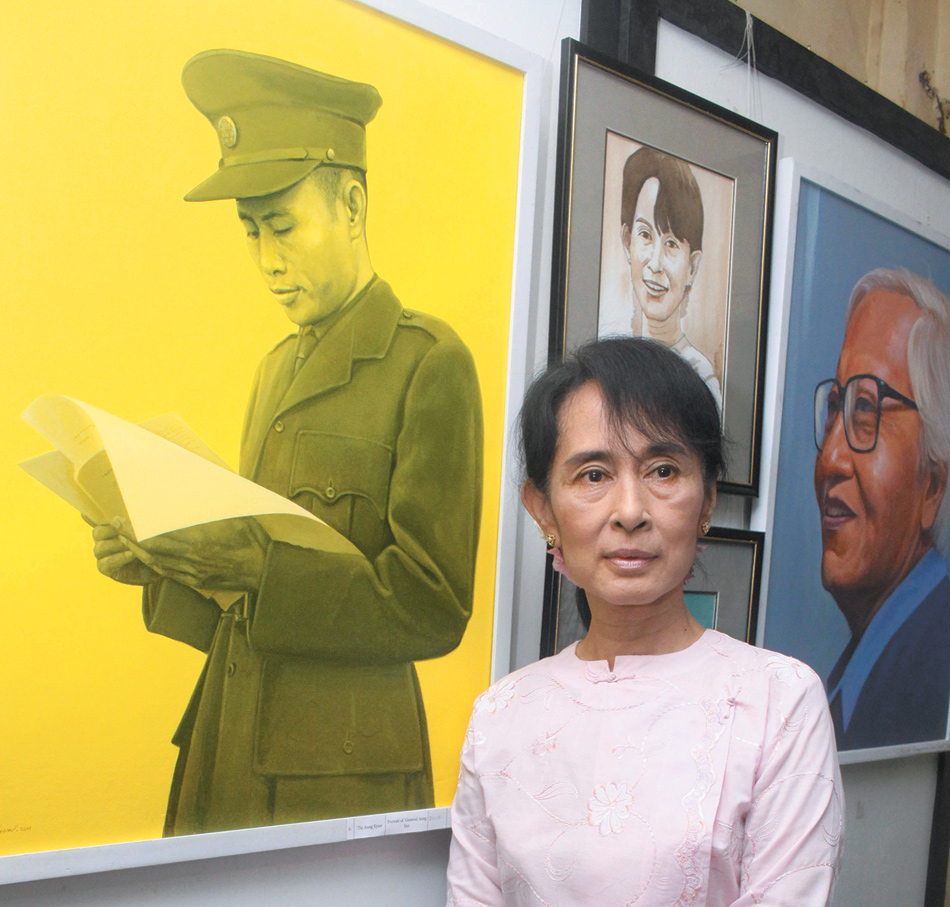 Aung San Suu Kyi standing in front of a painting of her father, General Aung San, Rangoon, October 2011