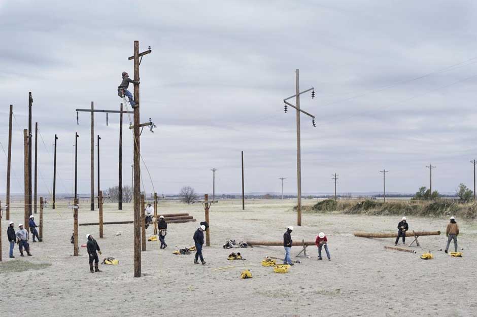 Workers putting up telephone poles, Nebraska, 2012