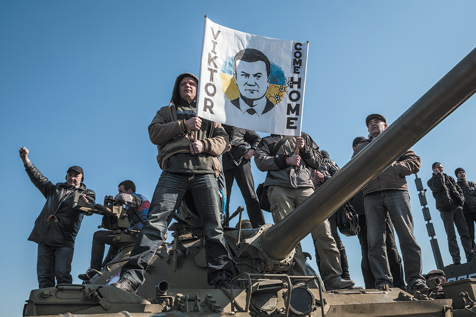 Pro-Russian demonstrators in Donetsk, with a sign showing the ousted Ukrainian president, Viktor Yanukovych, who was born in the province of Donetsk and had been its governor prior to his presidency, March 30, 2014