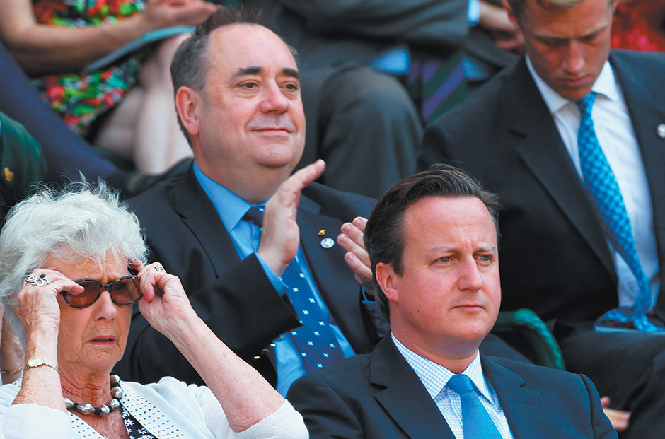 Scottish First Minister Alex Salmond (center), British Prime Minister David Cameron, and Cameron’s mother, Mary, at the Wimbledon tennis championships, London, July 2013